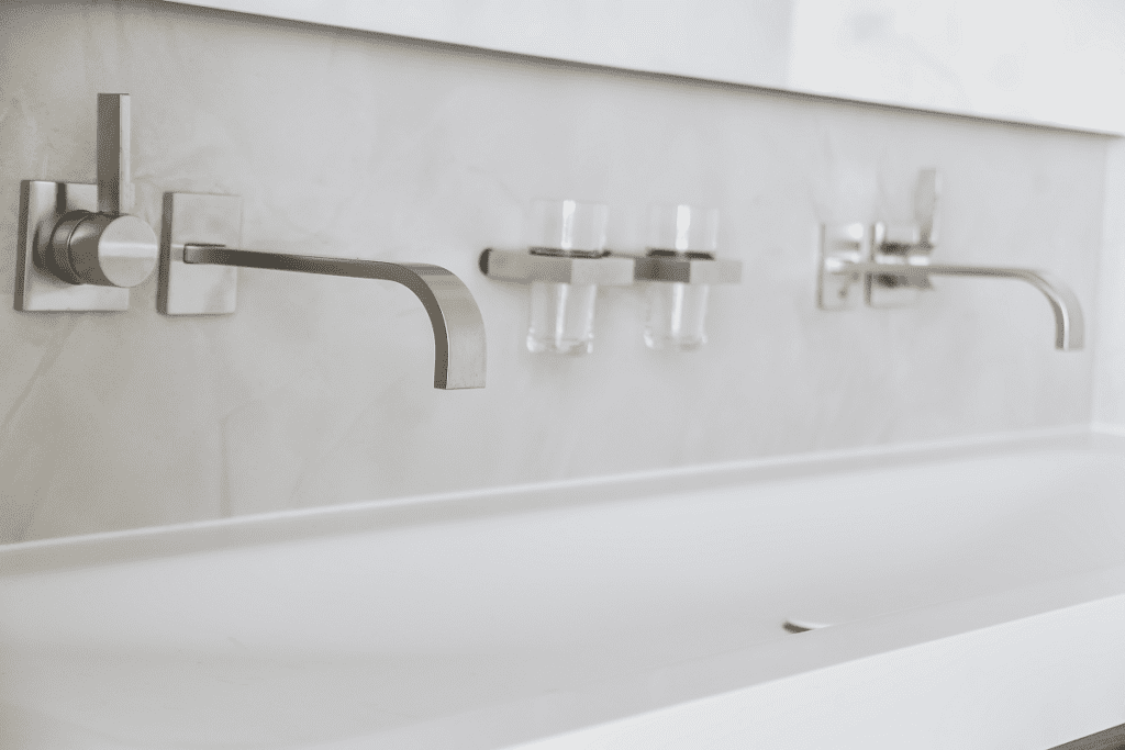 shiny-wall-mount-faucets-above-basin-min-1024×683