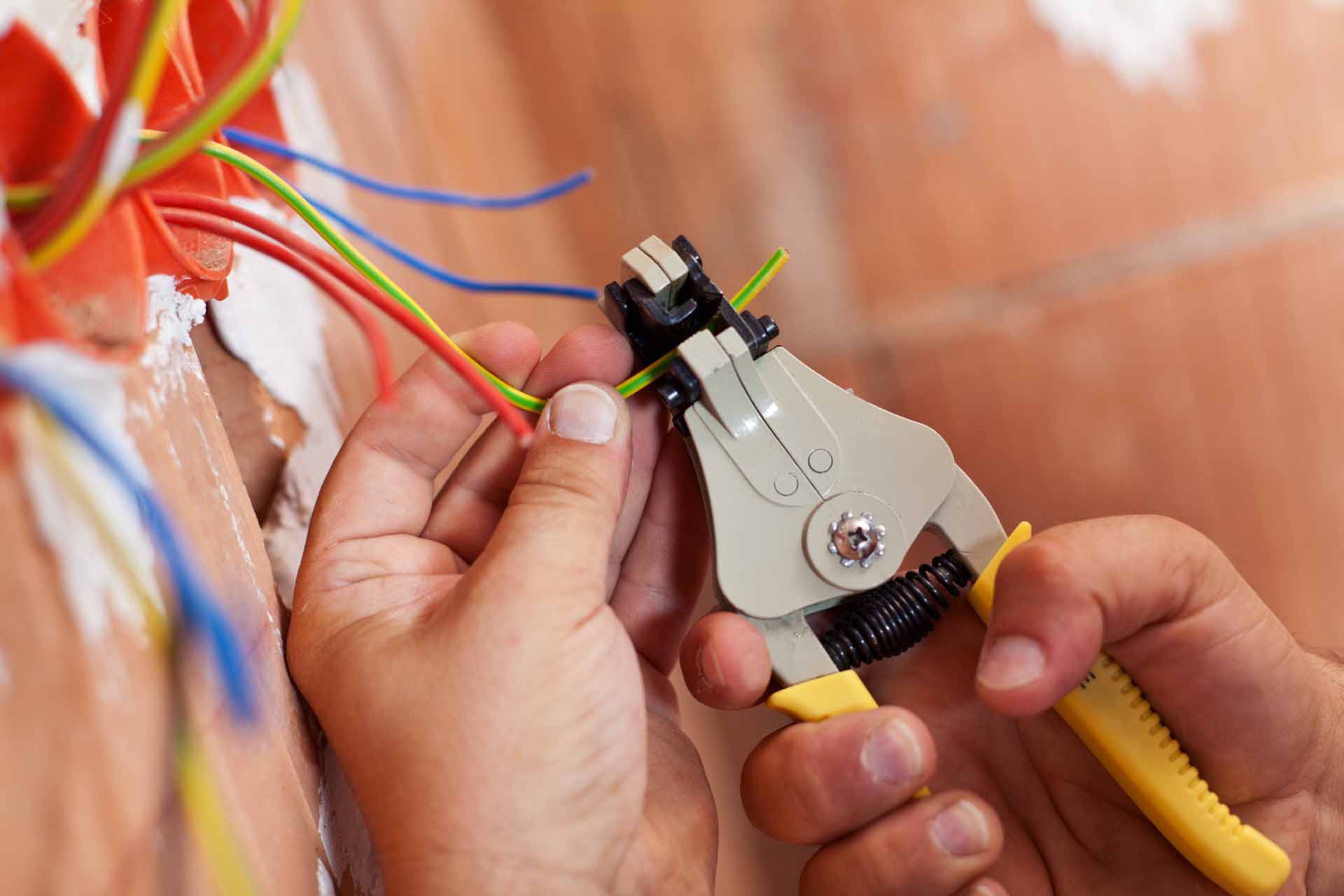 Electrician peeling off wires